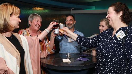 Smith Currie Hancock employees toast to their inclusion in the top small workplaces.