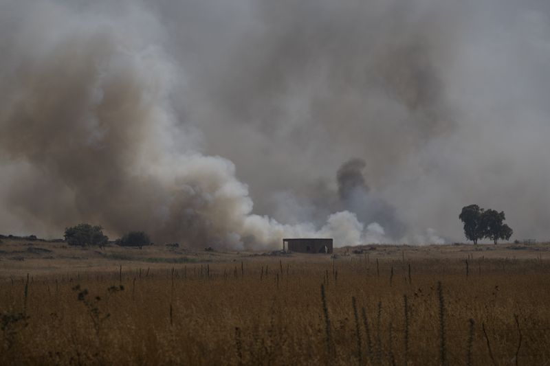 FILE - Smoke rises to the sky as a fire burns an area after a Lebanese shelling, in the Israeli-controlled Golan Heights, Thursday, June 13, 2024. (AP Photo/Leo Correa, File)
