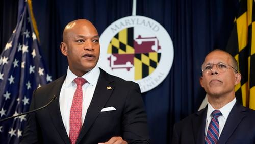 Maryland Gov. Wes Moore, left, flanked by Attorney General Anthony Brown, speaks during a news conference announcing a lawsuit seeking damages from the owners and managers of the Dali cargo ship that crashed into the Francis Key Scott Bridge, Tuesday, Sept. 24, 2024, in Baltimore. (AP Photo/Stephanie Scarbrough)