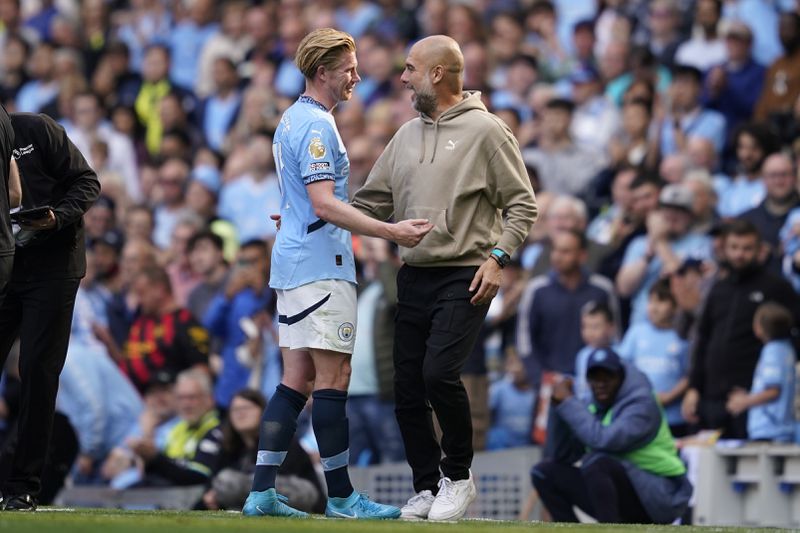 Manchester City's head coach Pep Guardiola talks with Kevin De Bruyne after being substitute during the English Premier League soccer match between Manchester City and Ipswich Town at the Etihad Stadium in Manchester, England, Saturday, Aug. 24, 2024. (AP Photo/Dave Thompson)