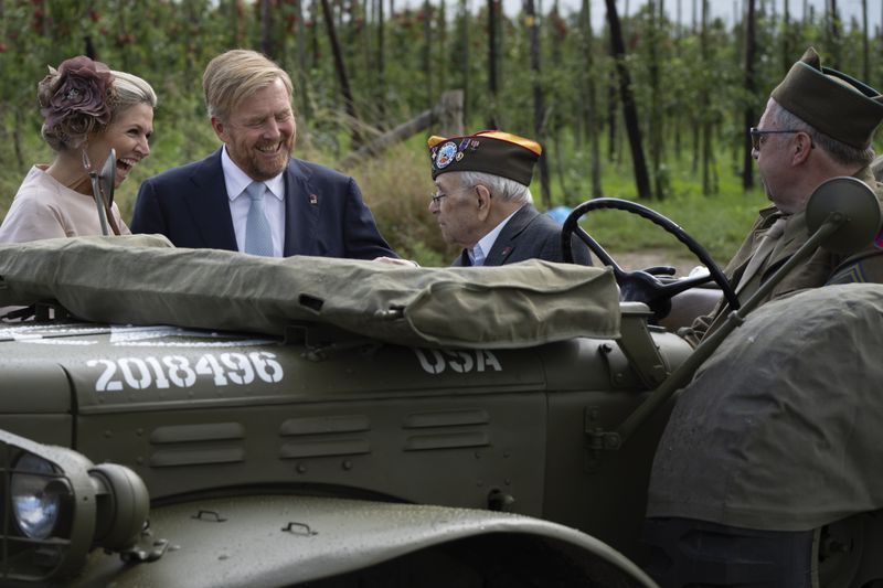 World War II veteran Kenneth Thayer is greeted by Dutch King Willem-Alexander and Queen Maxima before the royals joined Thayer in the jeep during a ceremony marking the 80th anniversary of the liberation of the south of the Netherlands in Mesch, Thursday, Sept. 12, 2024. (AP Photo/Peter Dejong, Pool)