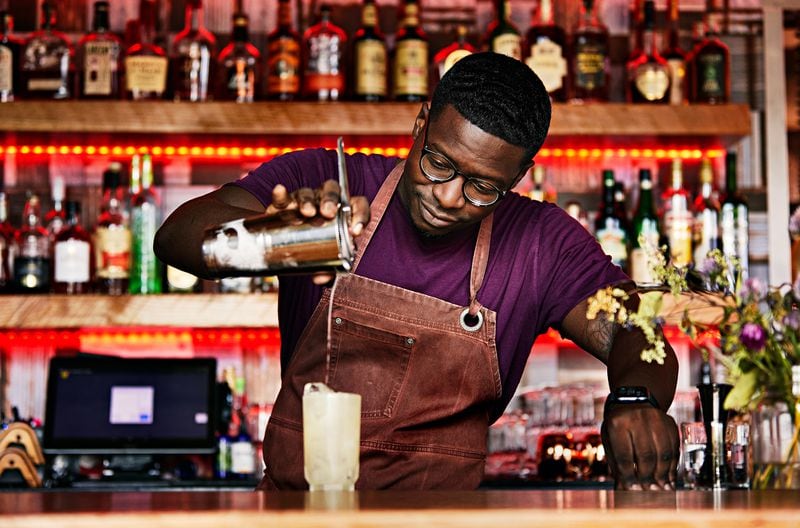 Mixologist Justin Hazelton pours a cocktail at Leah and Louise Restaurant