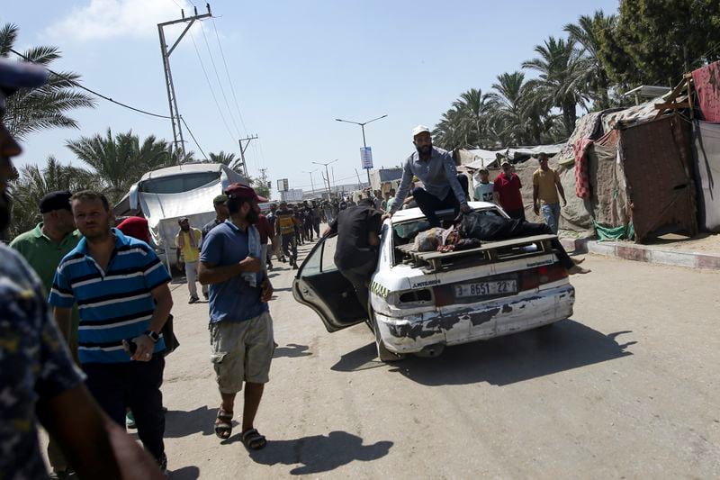 Palestinians evacuate the body of a woman from a site hit by an Israeli bombardment on Khan Younis, southern Gaza Strip, Saturday, July 13, 2024. Israel said it targeted Hamas' shadowy military commander in a massive strike Saturday in the crowded southern Gaza Strip that killed at least 71 people, according to local health officials. Hamas immediately rejected the claim that Mohammed Deif was targeted. (AP Photo/Jehad Alshrafi)