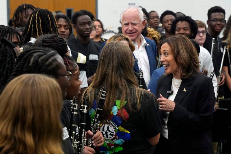 Kamala Harris and Tim Walz speak to marching band members at Liberty County High School.