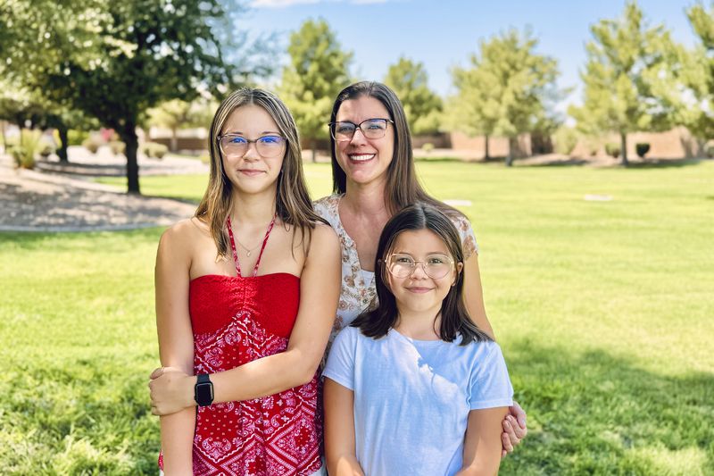 Audrey Jost stands with her daughters, Ellora, left, and Robyn, near their home in Gilbert, Ariz, on Aug. 10, 2024. (Ruth Doermann via AP)