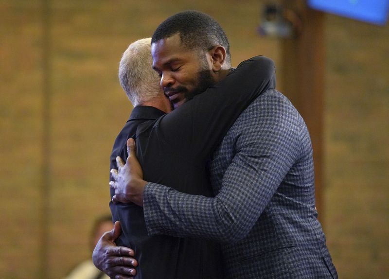 Carl Ruby, pastor at Central Christian Church, hugs Lindsay Aime during service, on Sunday, Sept. 15, 2024, in Springfield, Ohio. (AP Photo/Jessie Wardarski)