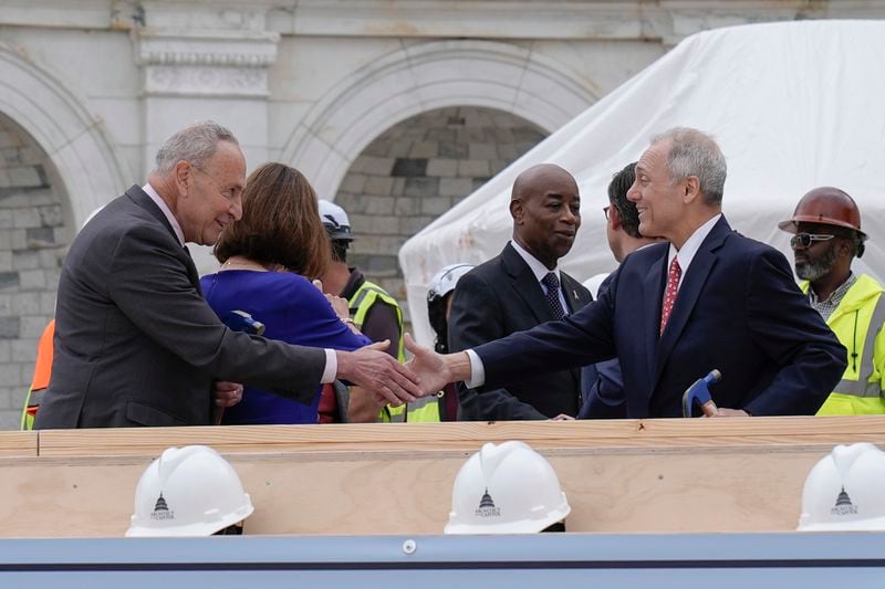 House Majority Leader Steve Scalise, R-La., right and Senate Majority Leader Chuck Schumer, D-N.Y., are seen after the First Nail Ceremony marking the beginning of construction of the 2025 Presidential Inauguration platform, on the steps of the Capitol, Wednesday, Sept. 18, 2024, in Washington. (AP Photo/Mariam Zuhaib)