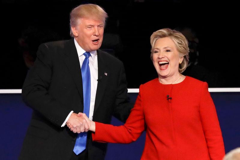 FILE - Republican presidential nominee Donald Trump, left, and Democratic presidential nominee Hillary Clinton shake hands after the presidential debate in Hempstead, N.Y., Sept. 26, 2016. (AP Photo/David Goldman, File)