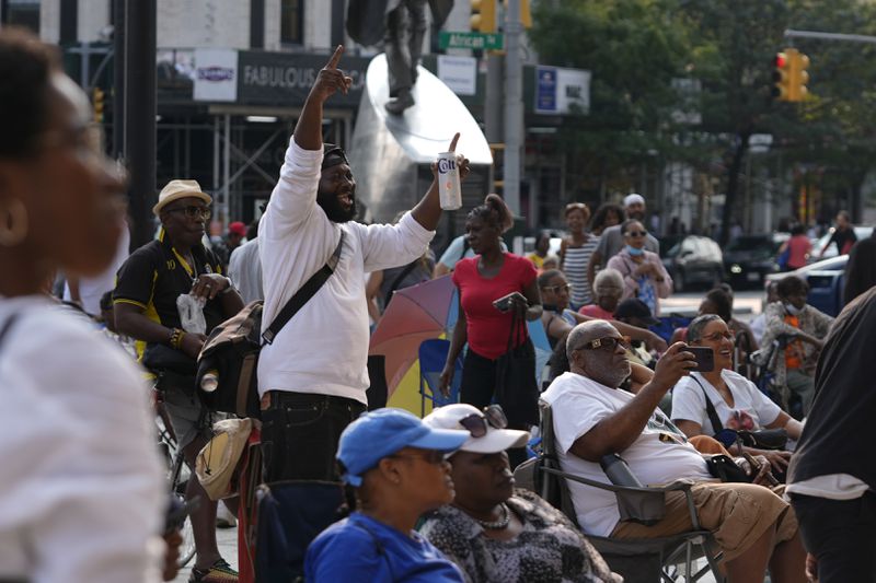 A man cheers as JSWISS performs in the Harlem neighborhood of New York, Thursday, Aug. 15, 2024. (AP Photo/Pamela Smith)