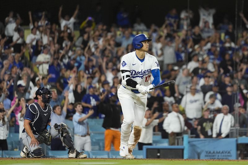 Los Angeles Dodgers designated hitter Shohei Ohtani (17) hits a grand slam during the ninth inning of a baseball game against the Tampa Bay Rays in Los Angeles, Friday, Aug. 23, 2024. The Dodgers won 7-3. Will Smith, Tommy Edman, and Max Muncy also scored. (AP Photo/Ashley Landis)