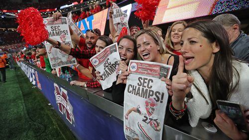 December 2, 2017 Atlanta: Georgia fans celebrate after the Bulldogs defeated Auburn 28-7 during the SEC Football Championship at Mercedes-Benz Stadium, December 2, 2017, in Atlanta.  Curtis Compton / ccompton@ajc.com