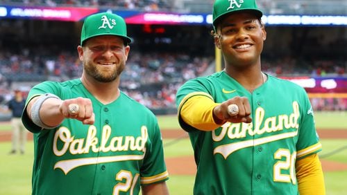 Former Atlanta Braves Stephen Vogt (left) and Cristian Pache, now with the Oakland Athletics, are presented their World Series rings before playing the Braves on Tuesday in Atlanta.  (Curtis Compton / Curtis.Compton@ajc.com)
