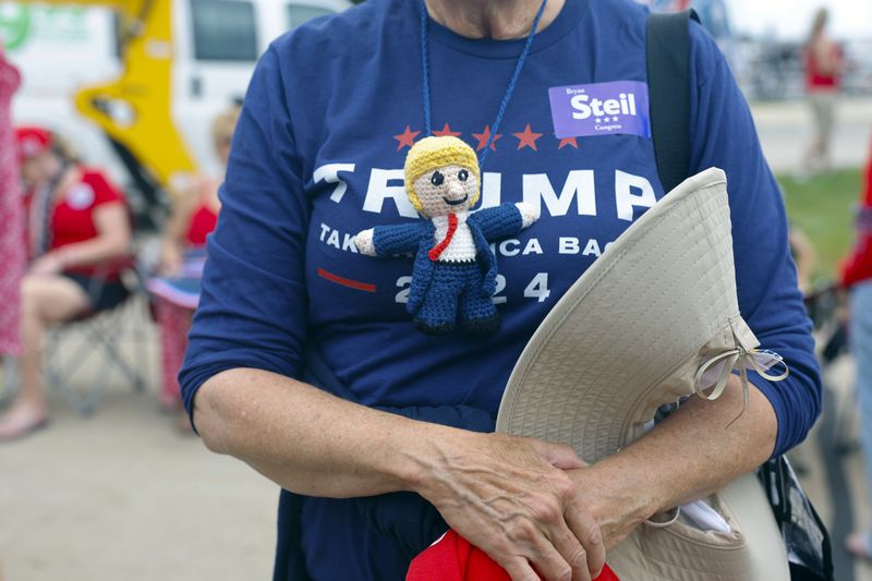 People wait in line to enter the venue where Republican presidential candidate former President Donald Trump will speak at a campaign event Tuesday, June 18, 2024, in Racine, Wis. (AP Photo/Jeffrey Phelps)