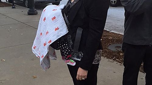 Attorney Stacy Ehrisman-Mickle waits outside immigration court with her month-old daughter after being denied a continuance by Judge J. Dan Pelletier.