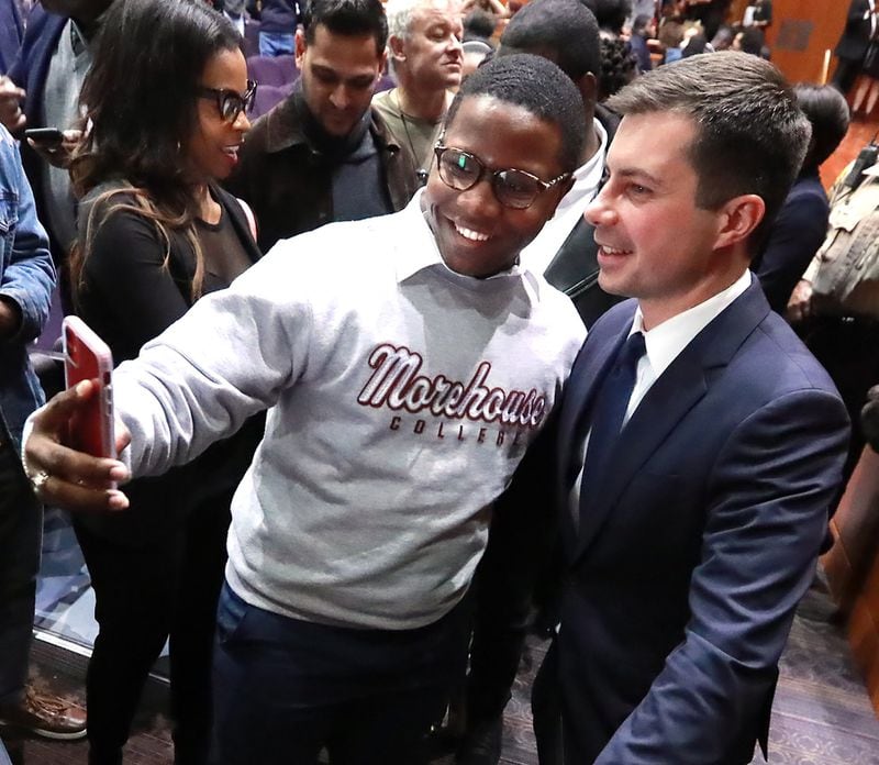 Morehouse College student Keron Campbell snaps a selfie with presidential hopeful Pete Buttigieg, mayor of South Bend, Indiana, as he greets students after speaking while launching a new effort to win over black voters during a conversation at Morehouse College on Monday, November 18, 2019, in Atlanta. CURTIS COMPTON/AJC