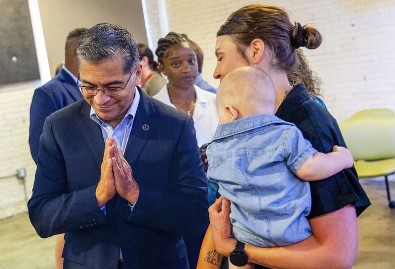 U.S. Health Secretary Xavier Becerra, left, thanks Jillaine St. Michel, holding 5-month-old Tucker, for participating after a conversation with local patients and providers who have been impacted by Idaho's abortion restrictions held at the Linen Building in Boise, Idaho, Wednesday, June 26, 2024. (AP Photo/Kyle Green)