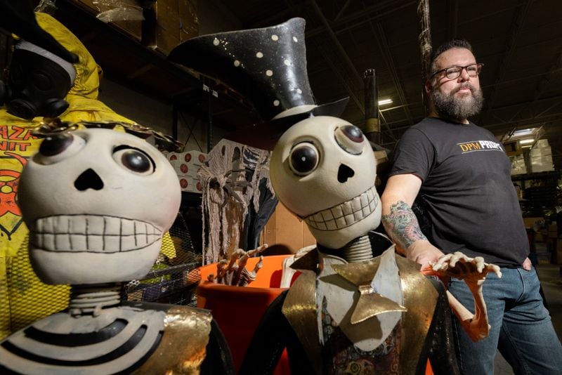 Thomas Kerns poses for a photo by some of his props in his Atlanta prop house Tuesday, July 25. (Steve Schaefer/steve.schaefer@ajc.com)