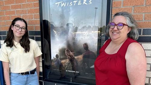 Grace Evans and her daughter, Charis Evans, stand outside the Regal Warren Theater in Moore, Okla., where they saw the film "Twisters." The theater, the top performing theater in the country for the film on opening weekend, was in the path of a giant tornado in 2013 that killed 24 people and injured hundreds more. (AP Photos/Sean Murphy)