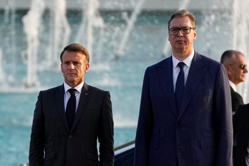 French President Emmanuel Macron, left, and Serbian President Aleksandar Vucic stand during a welcoming ceremony in Belgrade, Serbia, Thursday, Aug. 29, 2024. French President Emmanuel Macron starts a two-day state visit to Serbia with the focus on a possible sale of 12 Rafale multi-purpose fighter jets to a country that has maintained close ties to Russia despite its aggression on Ukraine. (AP Photo/Darko Vojinovic)