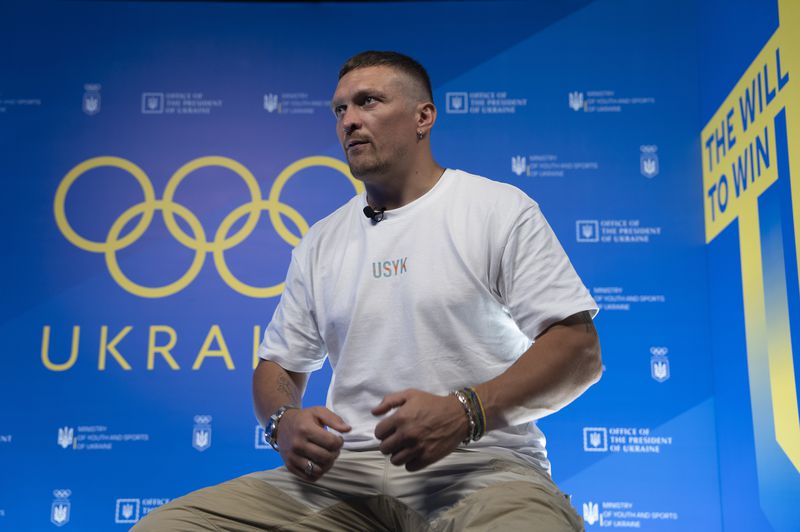 FILE - World Heavyweight boxing champion Oleksandr Usyk speaks during a visit to the Ukrainian House in Paris, France at the 2024 Summer Olympics, Monday, July 29, 2024. (AP Photo/Hanna Arhirova, File)