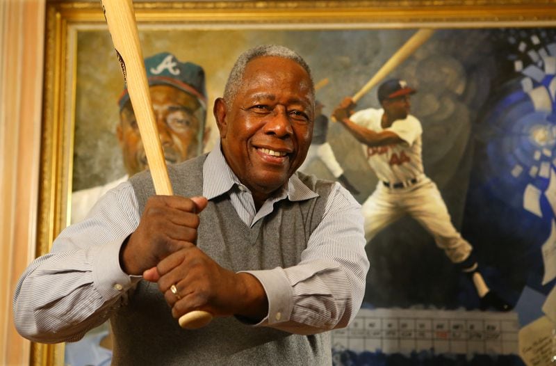 Braves legend Hank Aaron strikes a familiar pose during an interview in the living room of his home on the eve of his 80th birthday in Atlanta. CURTIS COMPTON / CCOMPTON@AJC.COM