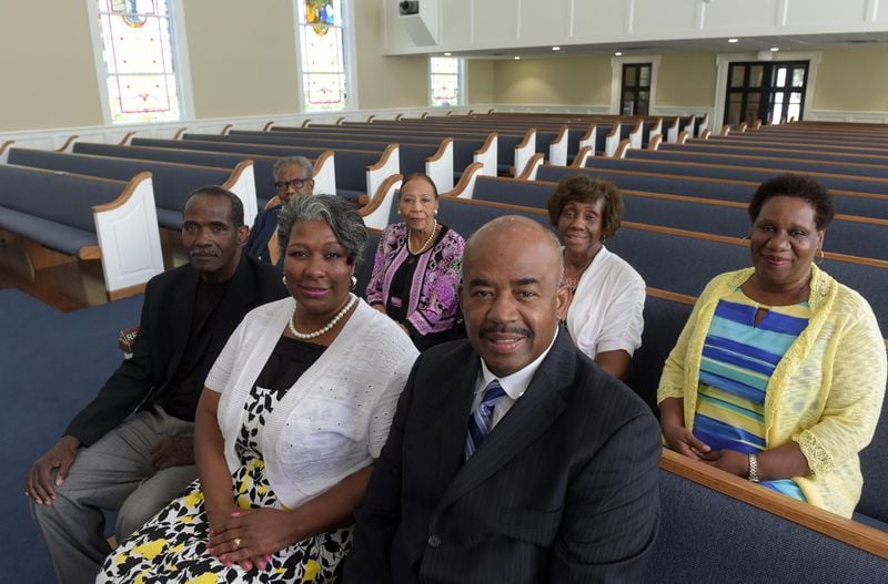 Pastor Rodney K. Turner (front row, right) and his wife, LaNett, and church officials Deacon Frank Hall (clockwise from left), Deacon Emeritus Willie Harris, trustee Bessie Streater, Ola Parker, church administrator and church clerk Angela Yarbrough, are shown at the Mount Vernon Baptist Church Wednesday, August 2, 2017. Mount Vernon was one of the two historic congregations that were forced to move to build the new Falcons stadium. KENT D. JOHNSON / AJC