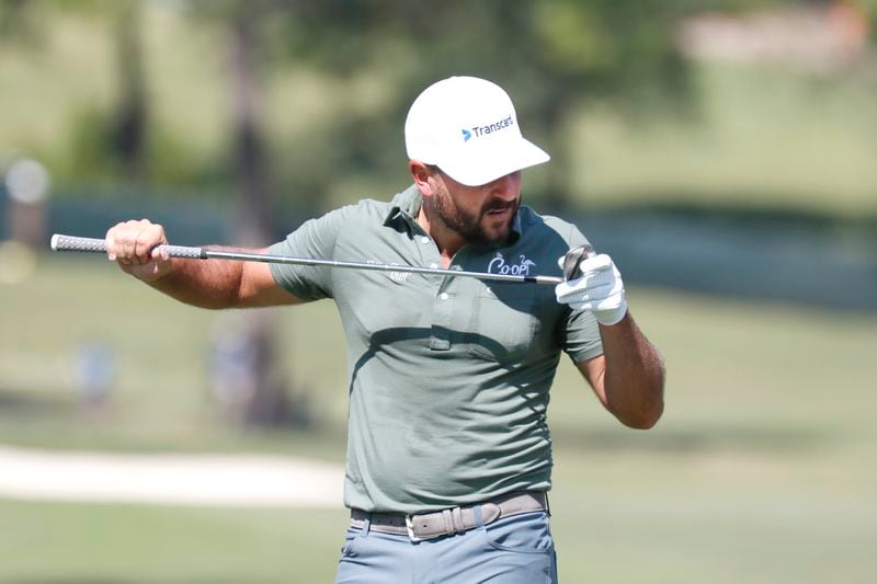 Stephan Jaeger inspects his club on the first hole during the fourth round of the 2024 Sanderson Farms Championship at the Country Club of Jackson on Oct. 06, 2024 in Jackson, Miss. (AP Photo/Sarah Warnock).