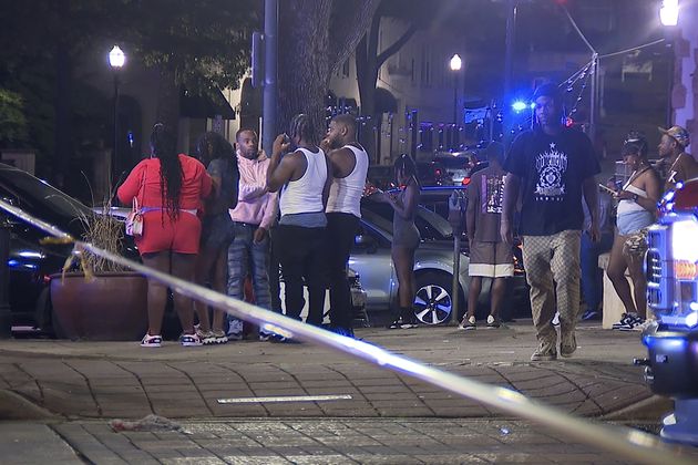 This image provided by WBMA shows bystanders near the scene of a shooting in Birmingham, Ala., Sunday, Sept. 22, 2024. (Bill Castle/WBMA via AP)