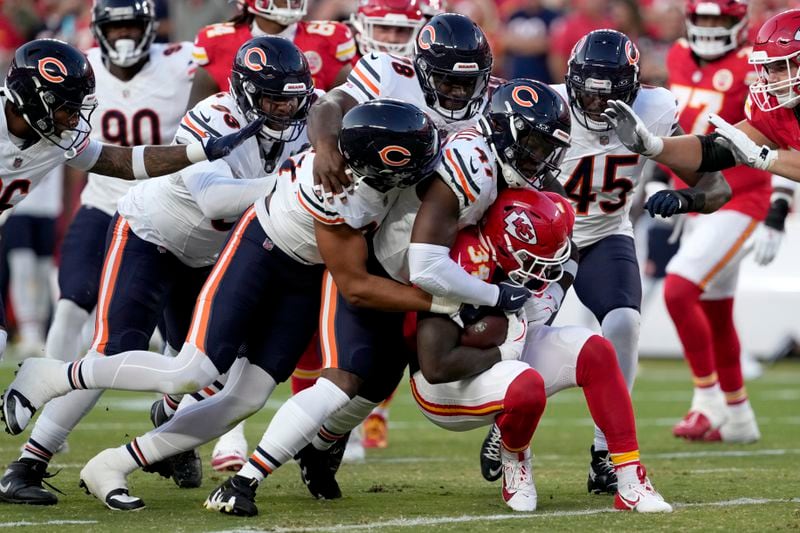 Kansas City Chiefs running back Deneric Prince (34) is stopped by a host of Chicago Bears players during the first half of an NFL preseason football game Thursday, Aug. 22, 2024, in Kansas City, Mo. (AP Photo/Ed Zurga)