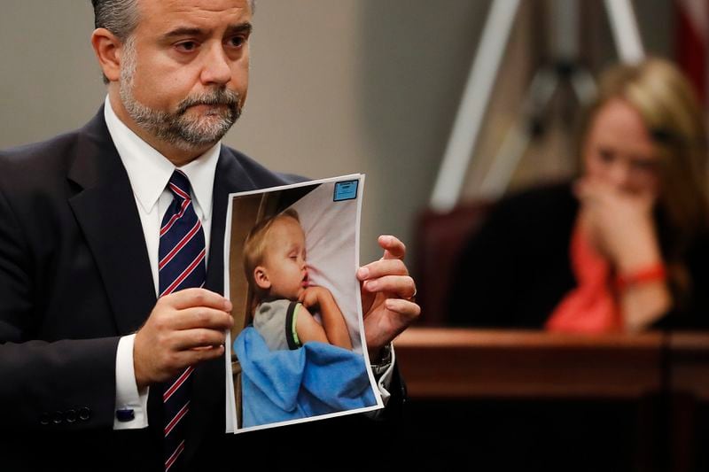 FILE - Defense attorney Maddox Kilgore holds a photo of Cooper Harris during the murder trial for his father, Justin Ross Harris, Oct. 31, 2016, in Brunswick, Ga. Georgia prison records show Harris was released from prison on Father's Day, Sunday, June 16, 2024, 10 years after his toddler died in a hot car, a case that made global headlines after prosecutors accused him of murder. (AP Photo/John Bazemore, Pool, File)