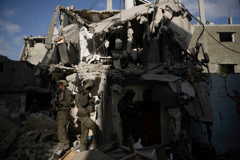 Israeli soldiers take up position next to destroyed buildings following Israeli strikes during a ground operation in the Gaza Strip on Friday, Sept. 13, 2024. (AP Photo/Leo Correa)