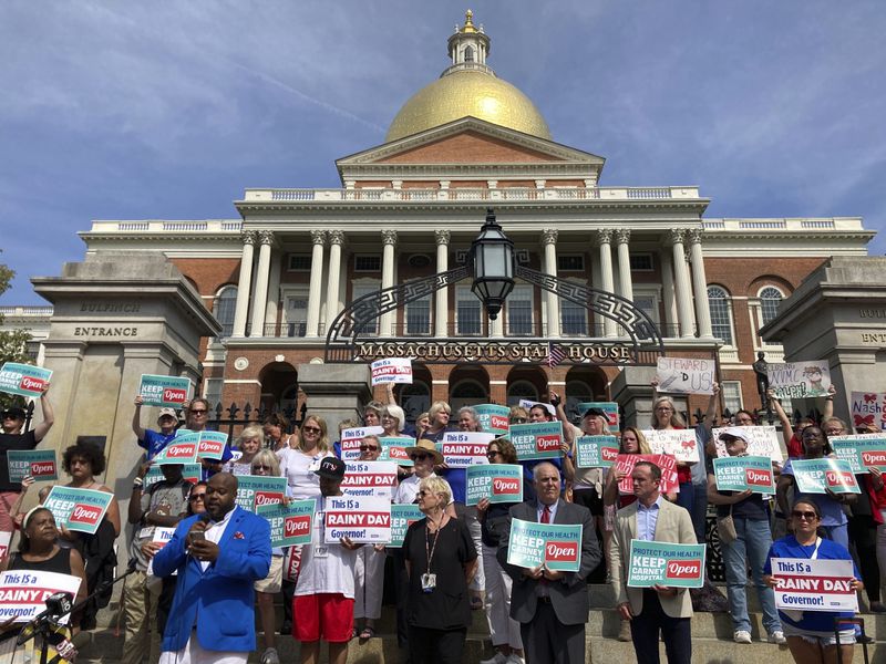 Protesters wanting to keep two Massachusetts hospitals open gather in front of the statehouse in Boston, Wednesday, Aug. 28, 2024. (AP Photo/Steve LeBlanc)