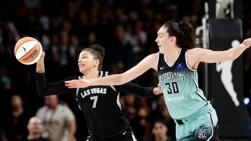 Las Vegas Aces forward Alysha Clark (7) picks off a pass intended for New York Liberty forward Breanna Stewart (30) during the first half of an WNBA basketball game Saturday, Aug. 17, 2024, in Las Vegas. (Steve Marcus/Las Vegas Sun via AP)