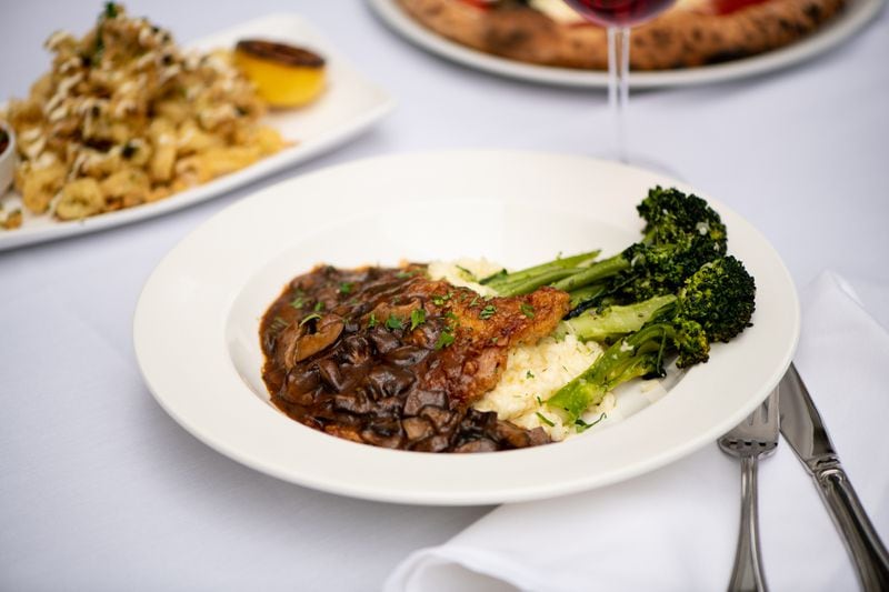 Amalfi Veal Marsala with mushroom Marsala wine sauce, Parmesan risotto, and Broccolini. (Mia Yakel for The Atlanta Journal-Constitution)