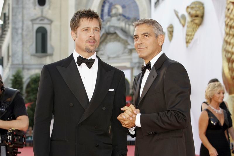 FILE - Actors Brad Pitt, left, and George Clooney appear at the screening of the movie "Burn After Reading," opening the 65th edition of the Venice Film Festival in Venice, Italy on Aug. 27, 2008. (AP Photo/Joel Ryan, File)