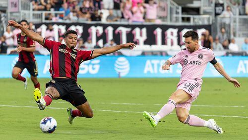 Inter Miami's Lionel Messi (10) takes a first-half shot at goal as Atlanta United defender Miles Robinson (12) applies pressure during a Leagues Cup group stage match at DRV PNK Stadium on Tuesday, July 25, 2023, in Fort Lauderdale, Florida. (Matias J. Ocner/Miami Herald/TNS)