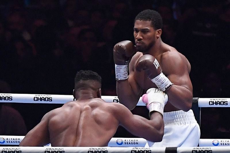 FILE - British former world champion Anthony Joshua, right, and MMA fighter Francis Ngannou fight during the heavyweight boxing showdown at Kingdom Arena in Riyadh, Saudi Arabia, Saturday, March 9, 2024. (AP Photo, file)