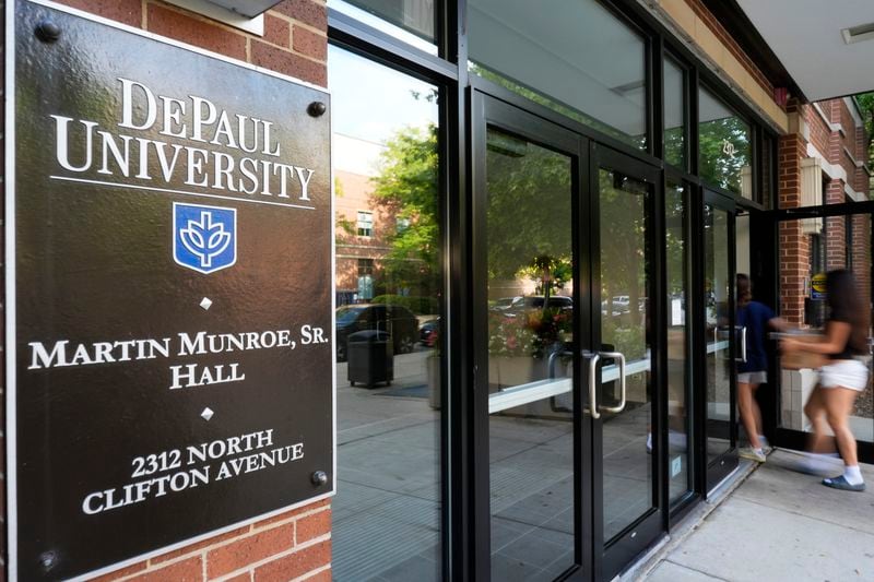 Students enter a dormitory at DePaul University in Chicago, Wednesday, Aug. 28, 2024. (AP Photo/Nam Y. Huh)