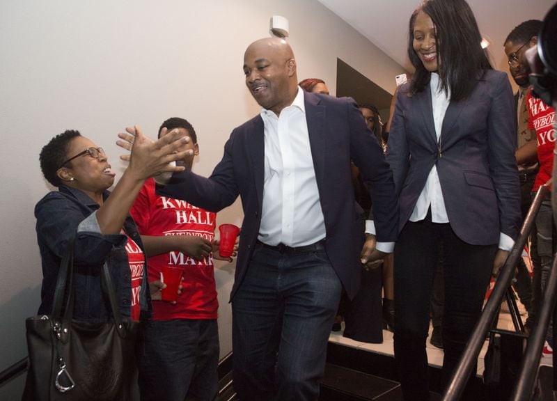 Atlanta mayoral candidate Kwanza Hall and his wife Natalie are greeted by fans and volunteers as their arrive at their election watch party.