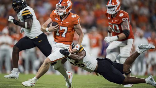 Appalachian State linebacker Caden Sullivan (26) tackles Clemson quarterback Christopher Vizzina (17) in the second half of an NCAA college football game Saturday, Sept. 7, 2024, in Clemson, S.C. (AP Photo/Jacob Kupferman)