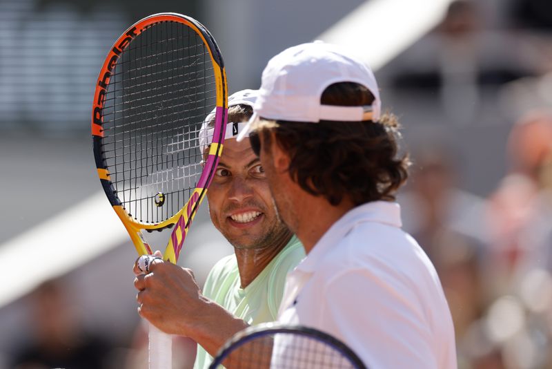 Spain's Rafael Nadal, left, talks with coach Carlos Moya during a training session at the Roland Garros stadium, Saturday, May 25, 2024 in Paris. The French Open tennis tournament starts Sunday May 26, 2024. (AP Photo/Jean-Francois Badias)