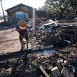 Chris Jordan, maintenance manager for Horseshoe Beach, tries to find a water shutoff valve amid the rubble of the destroyed city hall in the aftermath of Hurricane Helene, in Horseshoe Beach, Fla., Sunday, Sept. 29, 2024. (AP Photo/Gerald Herbert)