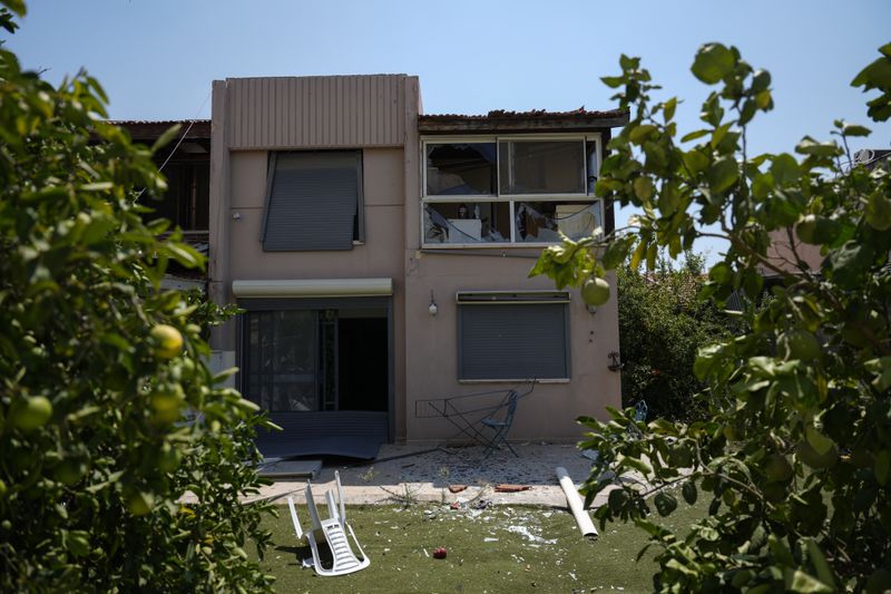 A damaged house is seen following an attack from Lebanon, in Acre, north Israel, Sunday, Aug. 25, 2024. (AP Photo/Ariel Schalit)