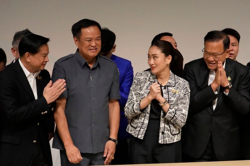 Leader of Pheu Thai Party, Paetongtarn Shinawatra, daughter of Thailand's former Prime Minister Thaksin Shinawatra, third form left, and coalition partners smiles during press conference in Bangkok, Thailand, Thursday, Aug. 15, 2024. (AP Photo/Sakchai Lalit)