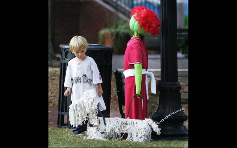 Taliesin Nelson, 3, of Marietta, does a double-take at one of the scarecrows on display on Marietta Square during the 2008 Harvest Square Arts and Crafts Festival. The event was renamed "HarvestFest" in 2015.