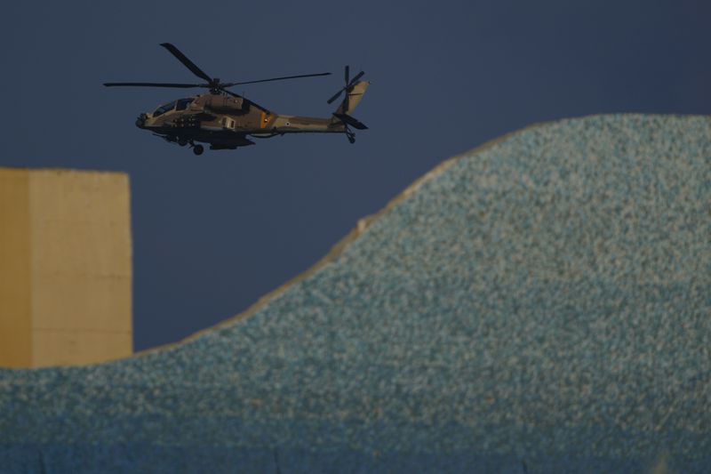 An Israeli Apache helicopter flies over Israel, Sunday, Aug. 25, 2024. (AP Photo/Ariel Schalit)