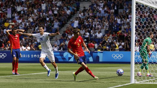 Uzbekistan's Eldor Shomurodov, second left, celebrates after scoring his team's first goal during the men's group C match between Uzbekistan and Spain at the Parc des Princes during the 2024 Summer Olympics, Wednesday, July 24, 2024, in Paris, France. (AP Photo/Aurelien Morissard)