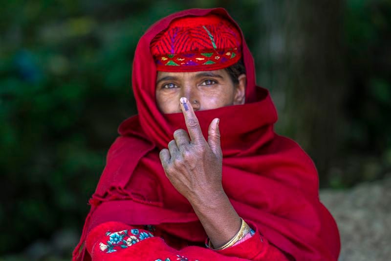Fatima Begum shows the indelible ink mark on her index finger after casting her vote during the sixth round of polling in India's national election in Khilan Village, south of Srinagar, Indian controlled Kashmir, Saturday, May 25, 2024. (AP Photo/Dar Yasin)