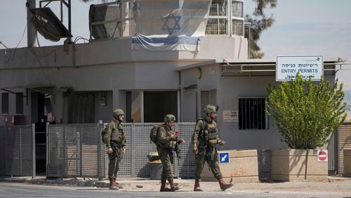 Israeli soldiers stand guard near the site of a deadly shooting attack where Israeli officials say three people were shot and killed at the Allenby Bridge Crossing between the West Bank and Jordan, Sunday, Sept. 8, 2024. (AP Photo/Mahmoud Illean)