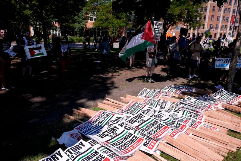 Protest signs are set out prior to a demonstration at Union Park during the Democratic National Convention Monday, Aug. 19, 2024, in Chicago. (AP Photo/Alex Brandon)